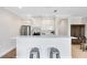 Bright kitchen with white cabinetry, stainless appliances, and a breakfast bar with seating at 1561 Corkery Ct, Winter Springs, FL 32708