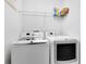 Well-equipped laundry room with modern washer and dryer and storage space at 1561 Corkery Ct, Winter Springs, FL 32708