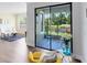 Living area leading to a screened patio with outdoor seating and a view of the pond at 1561 Corkery Ct, Winter Springs, FL 32708