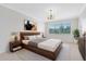 Primary bedroom with a king bed, a view out the window, and neutral decor at 1561 Corkery Ct, Winter Springs, FL 32708