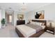 Spacious main bedroom featuring a king bed, elegant chandelier and neutral decor at 1561 Corkery Ct, Winter Springs, FL 32708