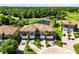 Stunning aerial view of homes near a pond, bridge and golf course surrounded by lush green trees at 1565 Corkery Ct, Winter Springs, FL 32708