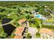 High angle view of the community showcasing the villas, community pool, golf course, and green spaces at 1565 Corkery Ct, Winter Springs, FL 32708