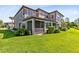 A lush backyard features a well-kept lawn, verdant landscaping, and a screened-in porch area at 1565 Corkery Ct, Winter Springs, FL 32708