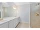 Bright bathroom featuring a dual sink vanity with tiled shower and glass door at 1565 Corkery Ct, Winter Springs, FL 32708