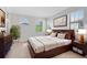 This cozy bedroom features a wood bed frame, a fluffy rug, and tons of natural light at 1565 Corkery Ct, Winter Springs, FL 32708
