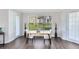 Elegant dining area with hardwood floors, modern lighting, and large windows overlooking a well maintained lawn at 1565 Corkery Ct, Winter Springs, FL 32708