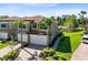 Two story home with attached garage, palm trees in the front yard, and a pond with bridge nearby at 1565 Corkery Ct, Winter Springs, FL 32708
