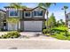 Beautiful two-story townhome with a brick driveway, attached garage, palm trees, and well-maintained landscaping at 1565 Corkery Ct, Winter Springs, FL 32708