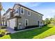Exterior view of a two-story gray home with a terra cotta roof, attached garage, and well-manicured lawn at 1565 Corkery Ct, Winter Springs, FL 32708