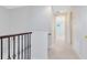 Bright hallway featuring neutral paint, carpet, and iron decorative elements at 1565 Corkery Ct, Winter Springs, FL 32708