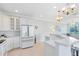 Well-lit kitchen featuring sleek white cabinets, modern appliances, a tile floor, and an open design at 1565 Corkery Ct, Winter Springs, FL 32708