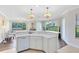 Bright kitchen with white cabinets, a dishwasher, and an open view to the dining and living areas at 1565 Corkery Ct, Winter Springs, FL 32708