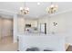 Bright kitchen with white cabinets, modern stainless steel appliances, and pendant lighting above breakfast bar at 1565 Corkery Ct, Winter Springs, FL 32708