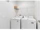 Functional laundry room featuring a washer and dryer, plus overhead shelving for storage at 1565 Corkery Ct, Winter Springs, FL 32708