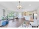 Spacious and bright living room with hardwood floors, chandelier lighting, and a view of the outdoors at 1565 Corkery Ct, Winter Springs, FL 32708
