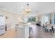 Open-concept living space featuring hardwood floors, elegant chandelier lighting, and a kitchen counter with bar stools at 1565 Corkery Ct, Winter Springs, FL 32708