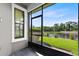 Enjoy serene water views from this screened patio with black trim windows and tile flooring at 1565 Corkery Ct, Winter Springs, FL 32708