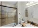 Well-lit bathroom with a glass-enclosed shower, granite countertop, and modern fixtures at 1613 Sapphire Star Dr, Oviedo, FL 32765