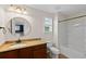 Bathroom featuring a granite countertop, bronze fixtures, and a combined shower and tub at 1613 Sapphire Star Dr, Oviedo, FL 32765