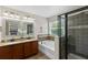 Bright bathroom featuring double vanity, separate shower, tub, and sleek design at 1613 Sapphire Star Dr, Oviedo, FL 32765