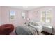 Cozy bedroom with pink walls, bright windows and modern decor at 1613 Sapphire Star Dr, Oviedo, FL 32765
