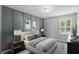 Stylish bedroom featuring panel accent wall, neutral decor, and a large window with bright, natural light at 1613 Sapphire Star Dr, Oviedo, FL 32765