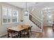 Bright dining room with modern light fixture, large windows, and staircase nearby at 1613 Sapphire Star Dr, Oviedo, FL 32765