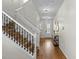 Welcoming foyer with staircase featuring hardwood floors, elegant lighting, and stylish decor at 1613 Sapphire Star Dr, Oviedo, FL 32765