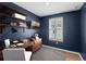Office space showcasing wood desk, shelving, and a window with natural light perfect for working from home at 1613 Sapphire Star Dr, Oviedo, FL 32765
