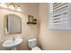 Powder room featuring pedestal sink, and decorative mirror, complemented by natural light at 1613 Sapphire Star Dr, Oviedo, FL 32765