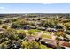 This is an aerial view of a residential neighborhood with mature trees and well-maintained lawns at 1725 Marcia Dr, Orlando, FL 32807
