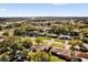 Wide aerial view displaying the property within a lush, tree-filled residential area at 1725 Marcia Dr, Orlando, FL 32807