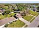 Aerial view showcases a home with a large yard, driveway, and neighboring residences at 1725 Marcia Dr, Orlando, FL 32807