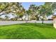 Large, well-maintained backyard with lush green grass and a white vinyl fence at 1725 Marcia Dr, Orlando, FL 32807