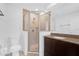 Bathroom with tiled shower with glass door, vanity with granite counter and updated toilet at 1725 Marcia Dr, Orlando, FL 32807