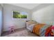 Bedroom with carpet, bright window view and is furnished with a bed and small piano at 1725 Marcia Dr, Orlando, FL 32807