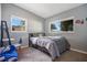 Bedroom with neutral walls, carpet, and two windows with views of the yard and neighborhood at 1725 Marcia Dr, Orlando, FL 32807