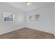 Bedroom with plush carpet, two windows, and freshly painted white walls at 1725 Marcia Dr, Orlando, FL 32807