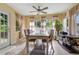 Dining room with neutral tile flooring, a modern ceiling fan, and natural light from three windows at 1725 Marcia Dr, Orlando, FL 32807