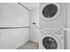Convenient laundry area featuring stacked washer and dryer for space-saving efficiency at 1725 Marcia Dr, Orlando, FL 32807