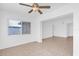 Bright living room featuring neutral tile flooring, a modern ceiling fan and large windows at 1725 Marcia Dr, Orlando, FL 32807