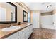 Bathroom with double sinks, large mirrors, bathtub, and neutral color scheme at 1802 Hagen Ct, St Cloud, FL 34771