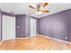 Bedroom with two doors, ceiling fan, and light hardwood floors at 1802 Hagen Ct, St Cloud, FL 34771