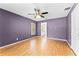 Bedroom with hardwood flooring, a ceiling fan, and light purple paint at 1802 Hagen Ct, St Cloud, FL 34771