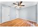 Bedroom with two doors, ceiling fan, and light hardwood floors at 1802 Hagen Ct, St Cloud, FL 34771