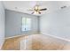 Light-filled bedroom features tiled floors, a ceiling fan, and a bright window at 1802 Hagen Ct, St Cloud, FL 34771
