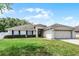 Charming single-story home with a well-maintained lawn, mature landscaping, and an attached two-car garage at 1802 Hagen Ct, St Cloud, FL 34771