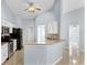 Bright kitchen with white cabinets, tile backsplash, and breakfast bar seating at 1802 Hagen Ct, St Cloud, FL 34771