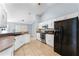 Kitchen view with stainless steel appliances, tile floors and black refrigerator at 1802 Hagen Ct, St Cloud, FL 34771
